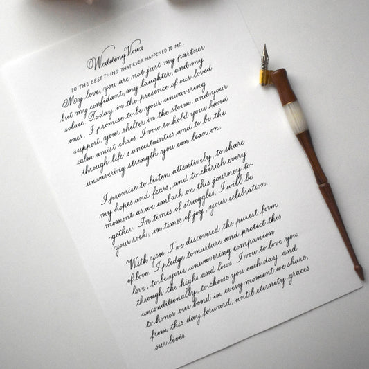 Flatlay of copperplate calligraphy letter with dip pen on A4 paper elegant handwritten script herpens