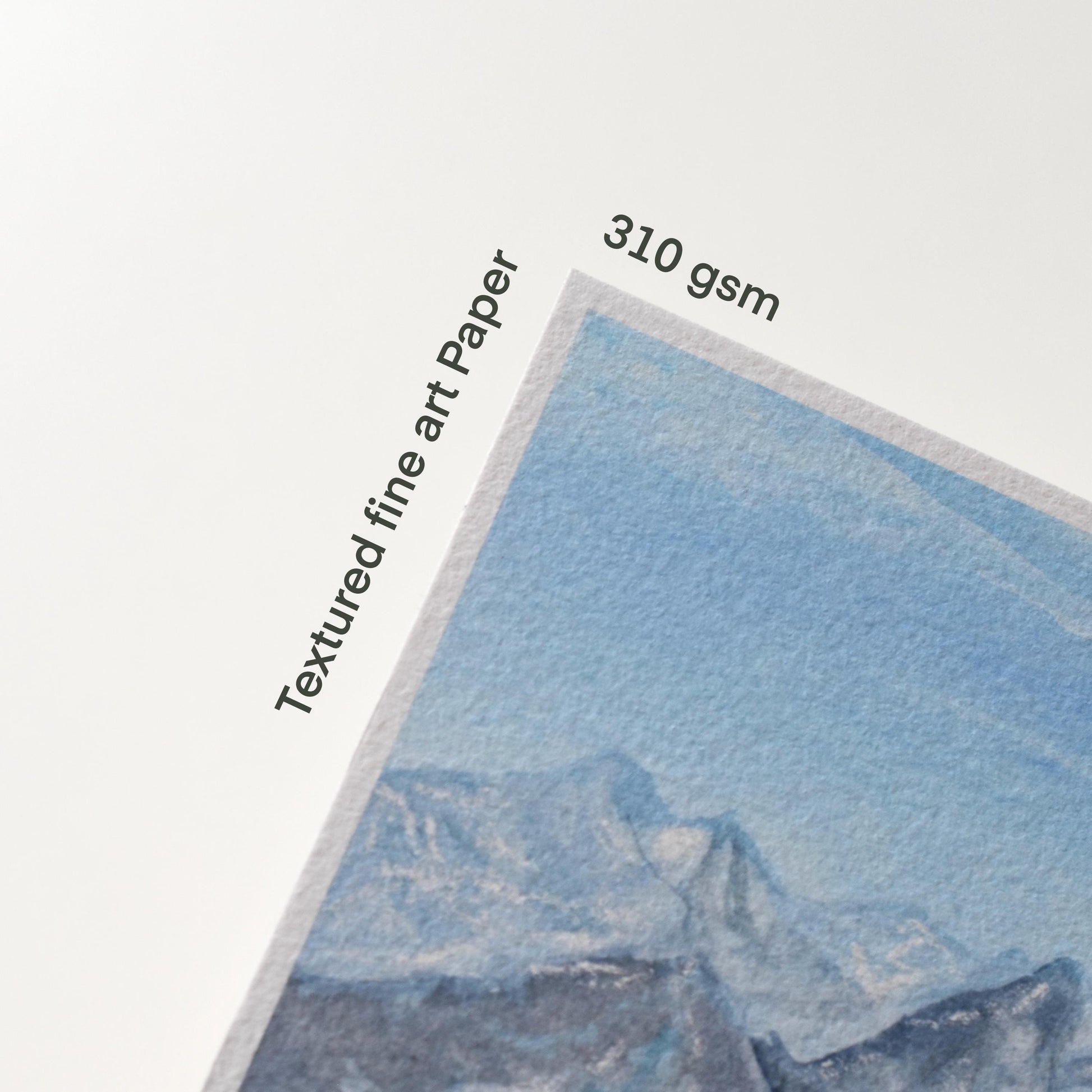Corner of the “Verdant Peaks” print with text labels “Textured fine art paper” and “310 gsm,” showing the paper texture and colour detail of the mountain painting.