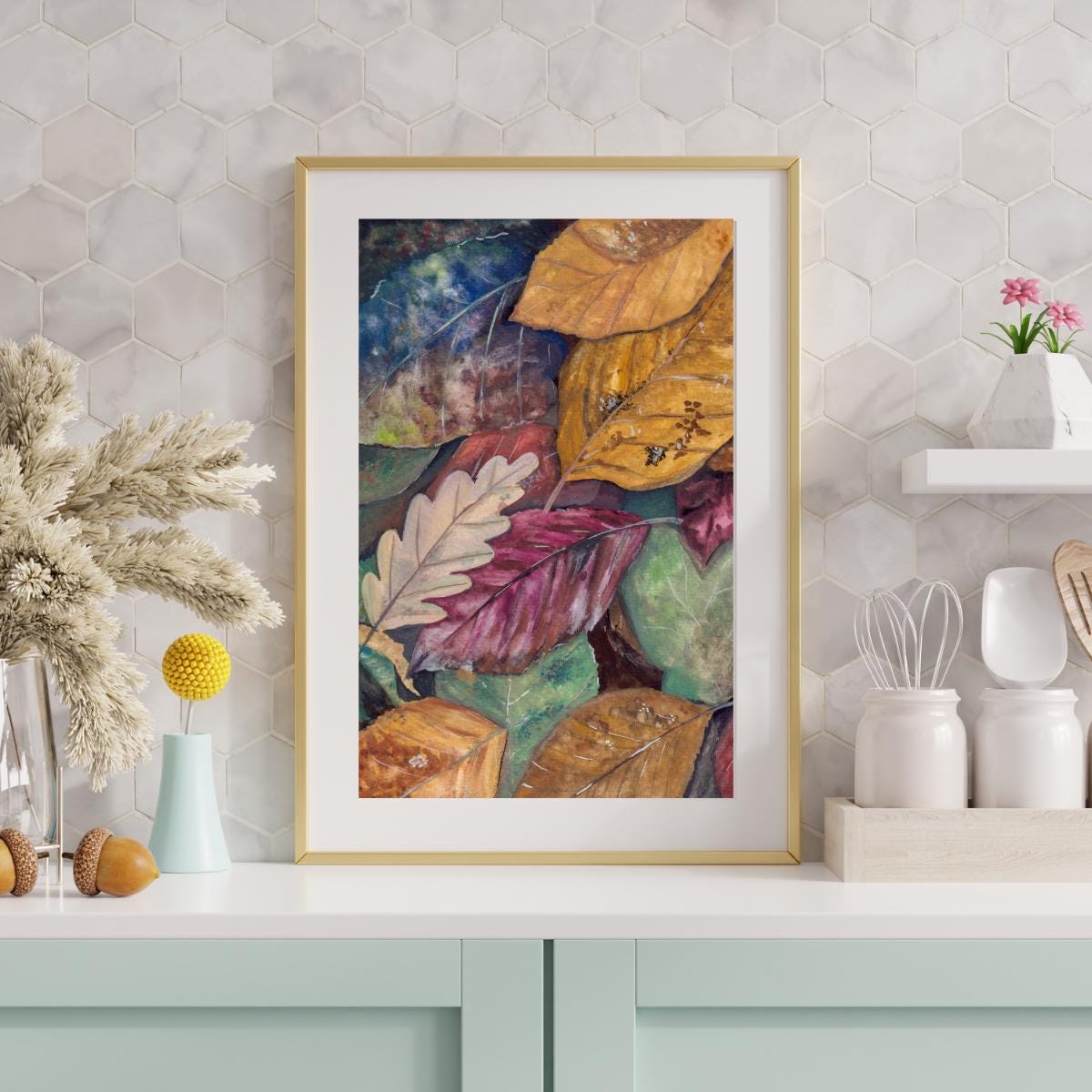Framed gouache “Colors of Autumn” digital artwork on a kitchen wall with hexagon tiles, cozy fall leaves illustration in warm seasonal tones, HerPens