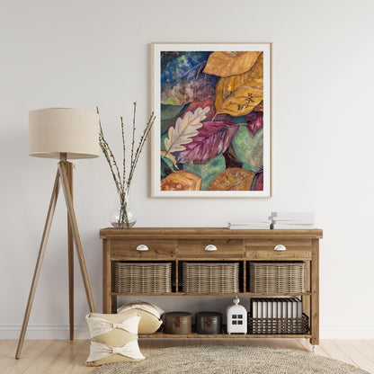 Framed gouache autumn leaves artwork on wooden console with lamp and plant, warm seasonal home décor digital print, HerPens