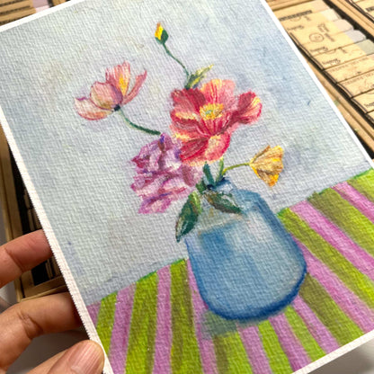 Hand holding floral oil pastel art print showing expressive strokes and textured paper surface, HerPens