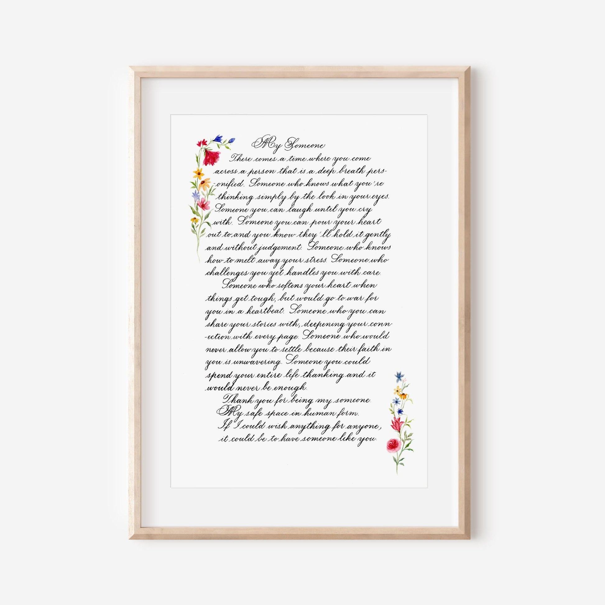 Framed handwritten calligraphy letter with floral watercolor border displayed as wall art