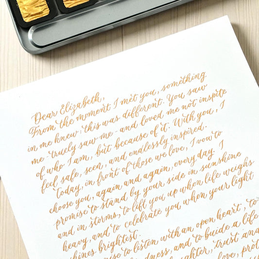 Handwritten gold ink calligraphy letter on white A4 paper elegant modern script wedding vows keepsake herpens