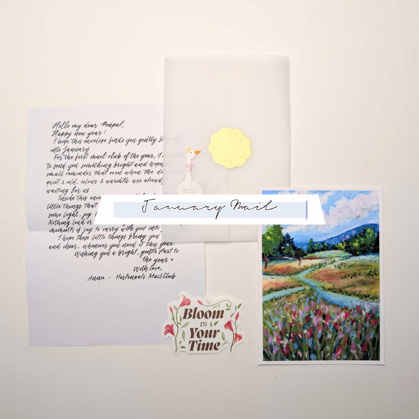 Greeting card with handwritten letter, envelope, and illustration of a landscape.