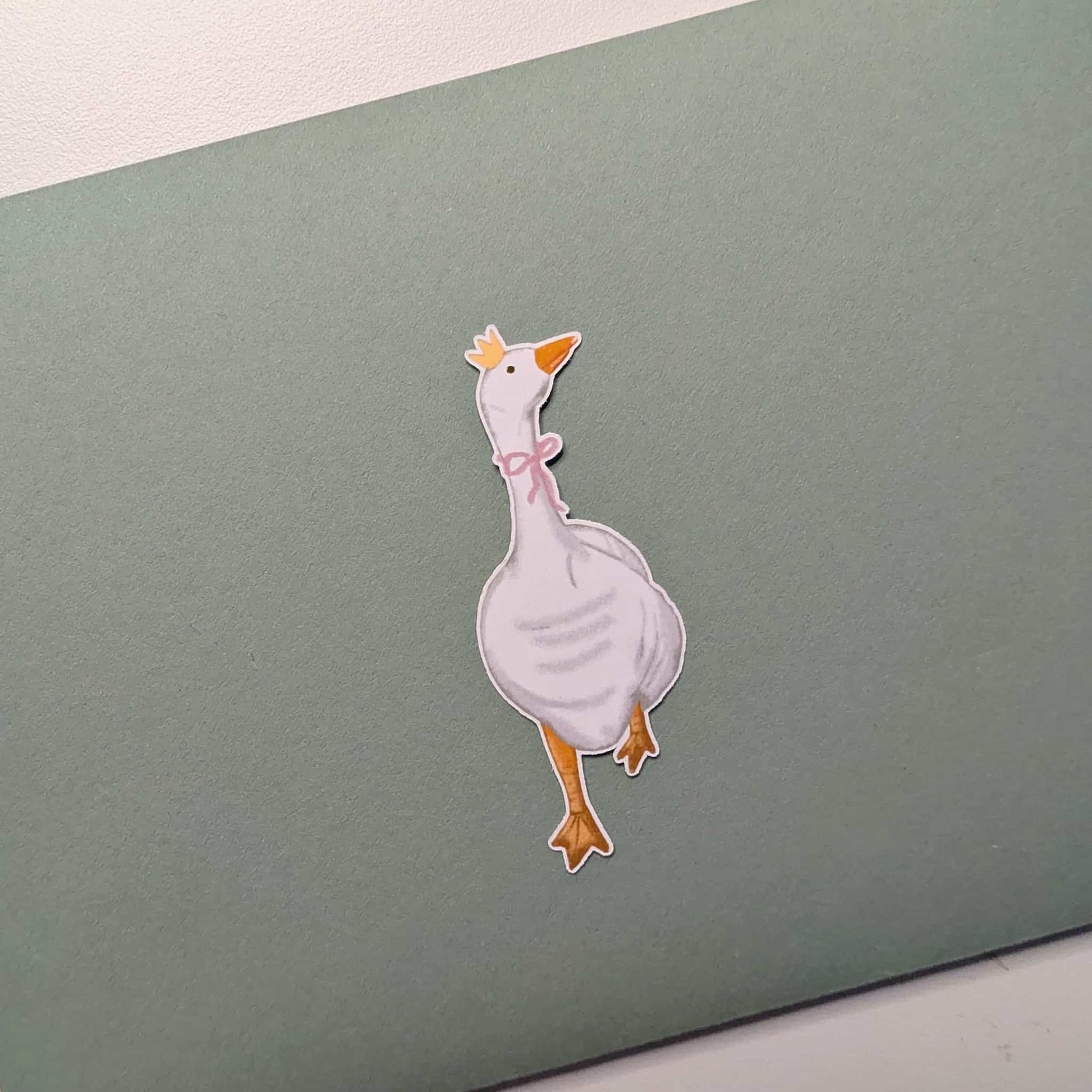 Cartoon duck sticker on a green card