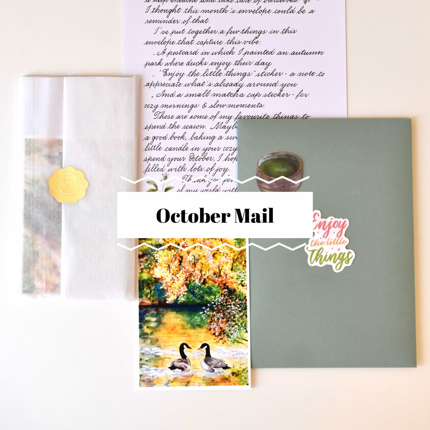 Collection of stationery items including a card with ducks, a letter, and a green envelope on a white background.