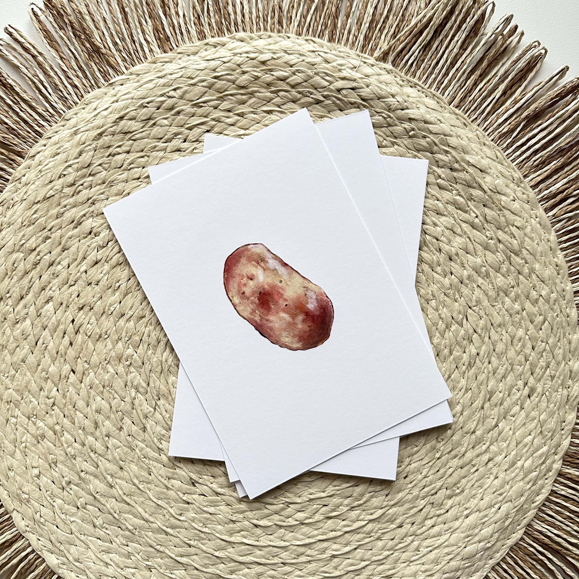 Stack of A6 oil pastel postcards with potato artwork on top — printed on fine matte paper, cozy kitchen art by HerPens.