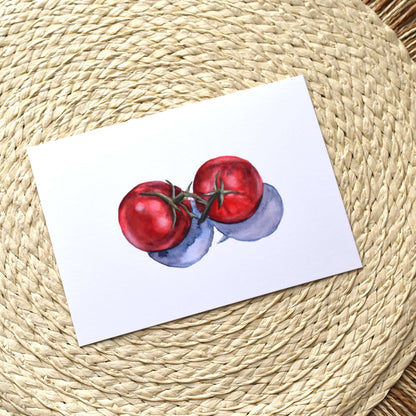 Art print of red tomatoes on a white background, placed on a woven mat.