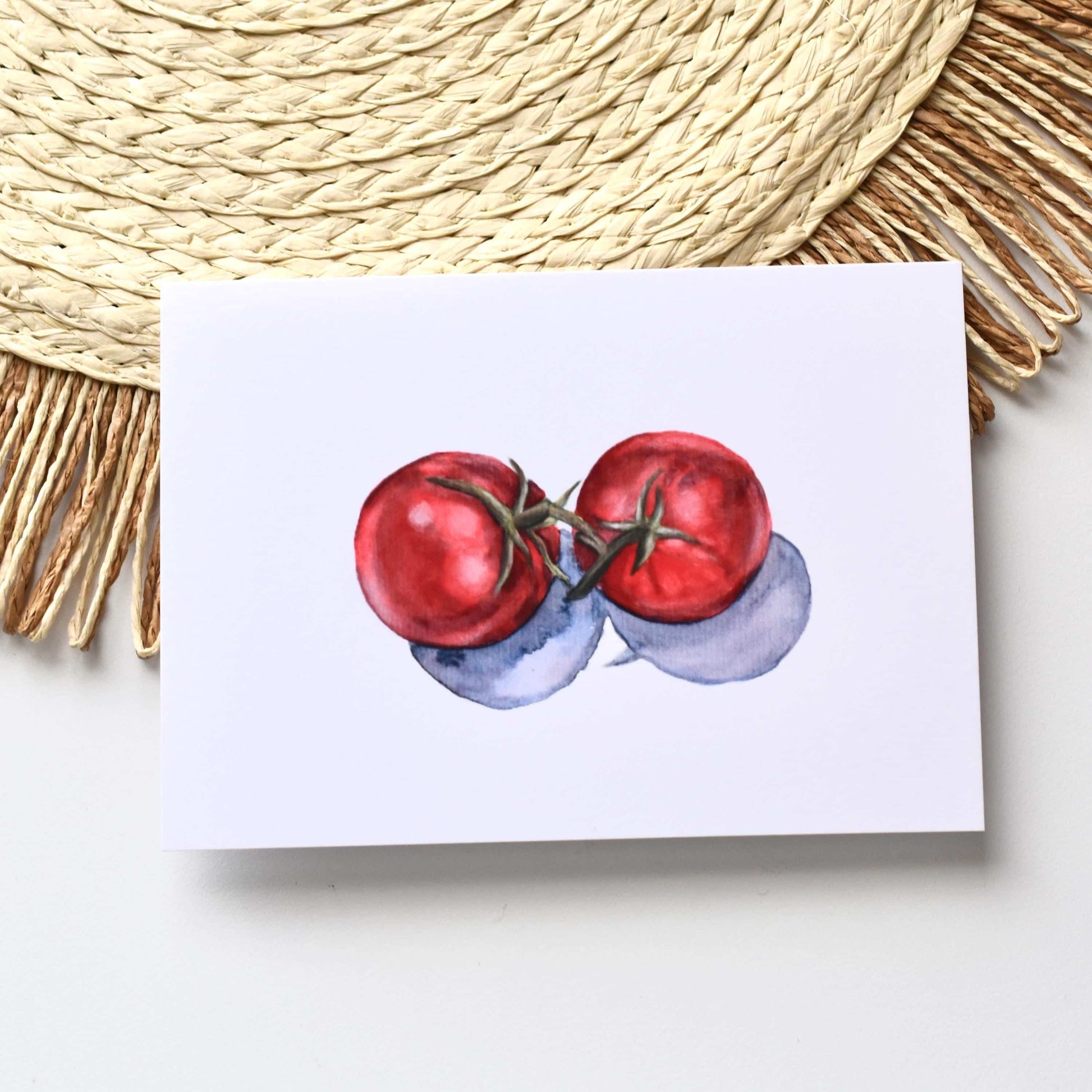 Notepad with a watercolor illustration of tomatoes on a textured surface