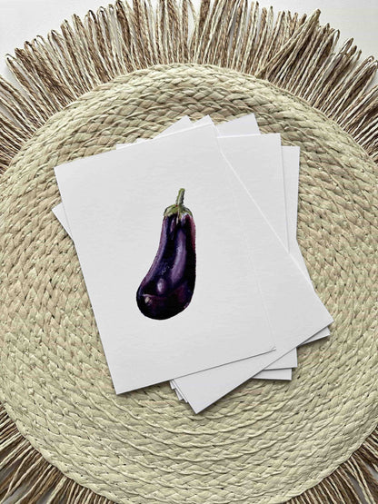 Eggplant on top of white cards on a woven placemat