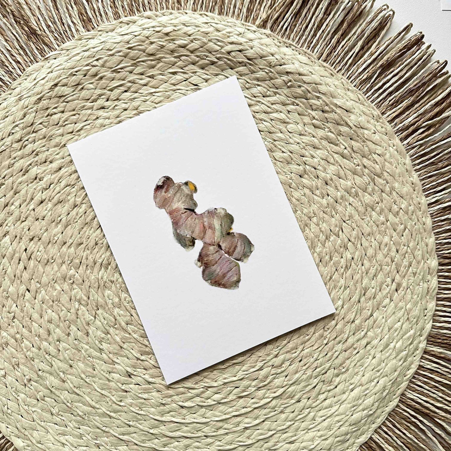 Note card with a butterfly illustration on a woven mat