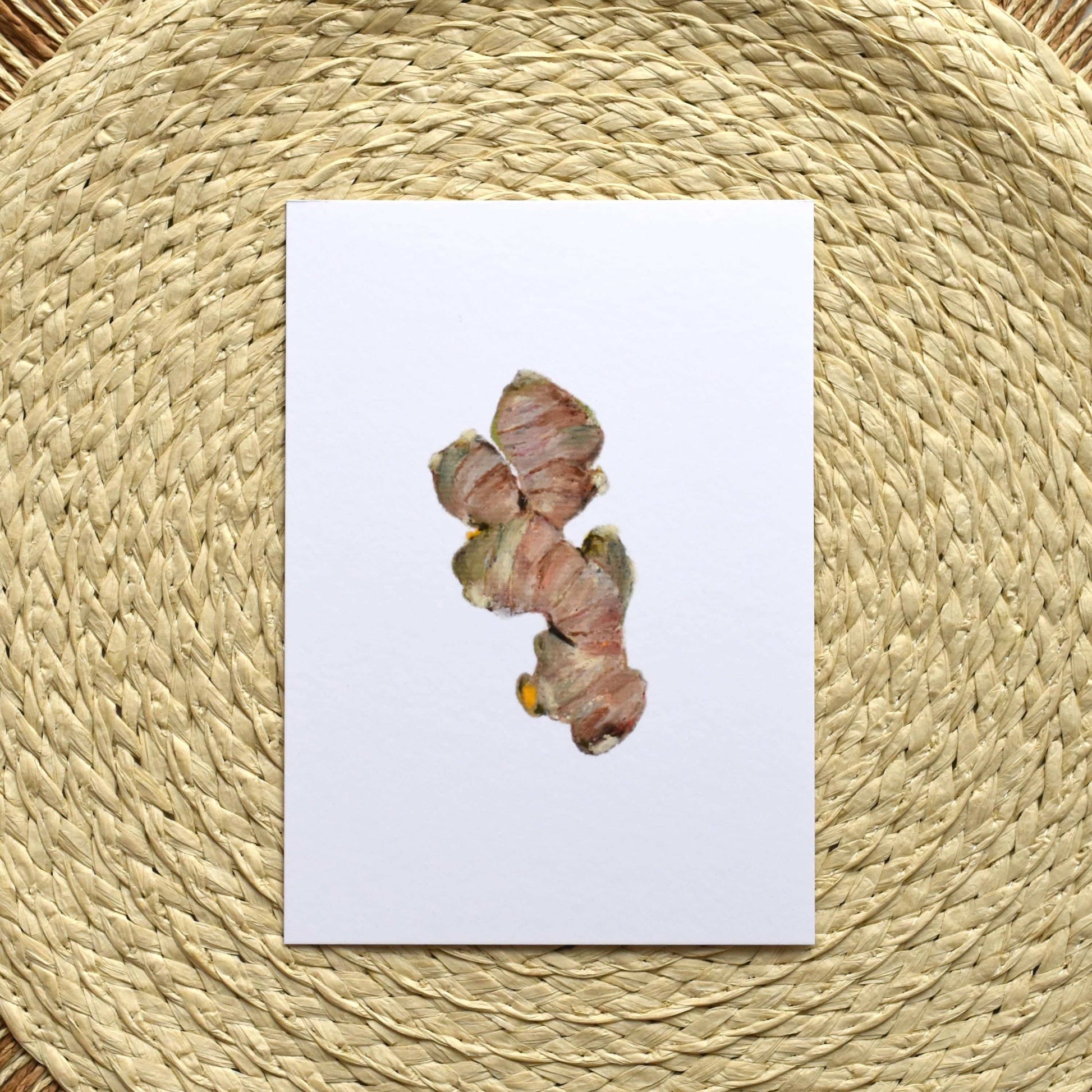 Turmeric root on a white card with a woven mat background