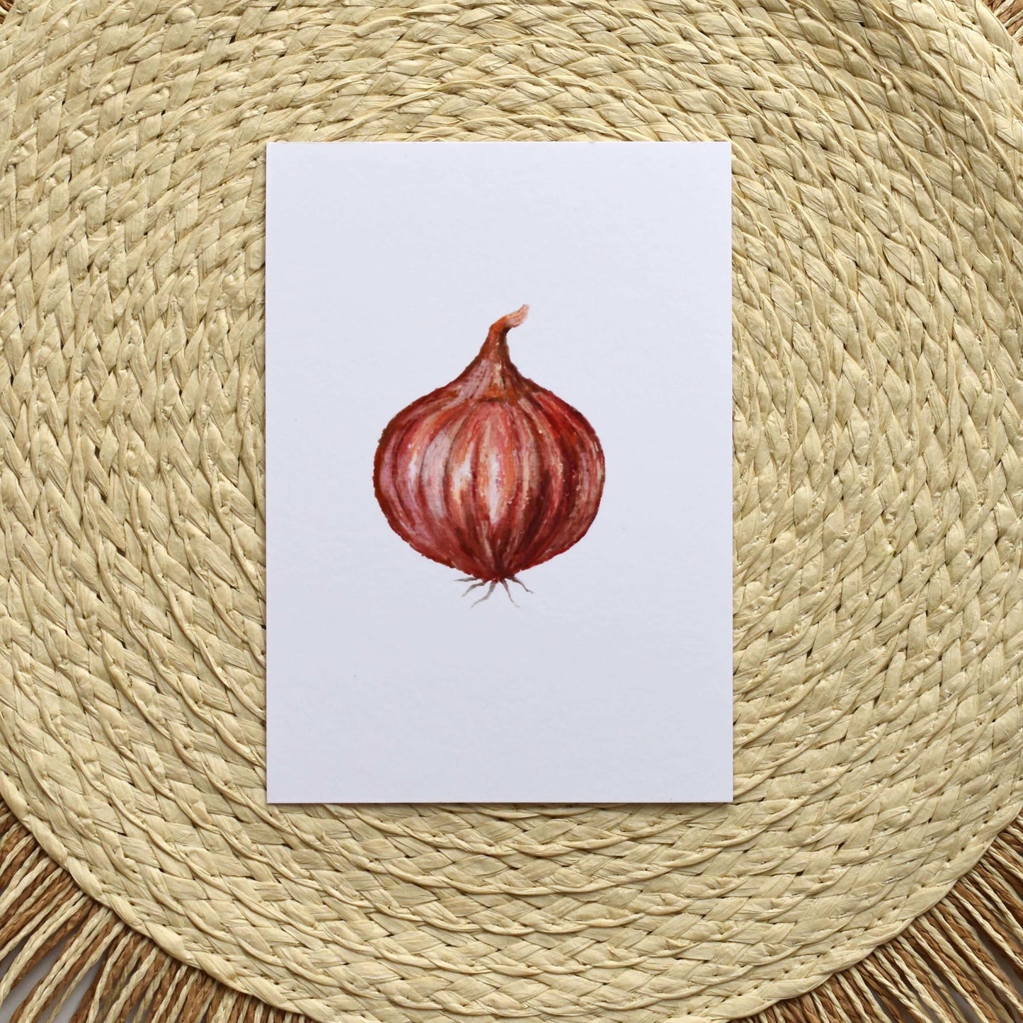 Card with a red onion illustration on a woven mat