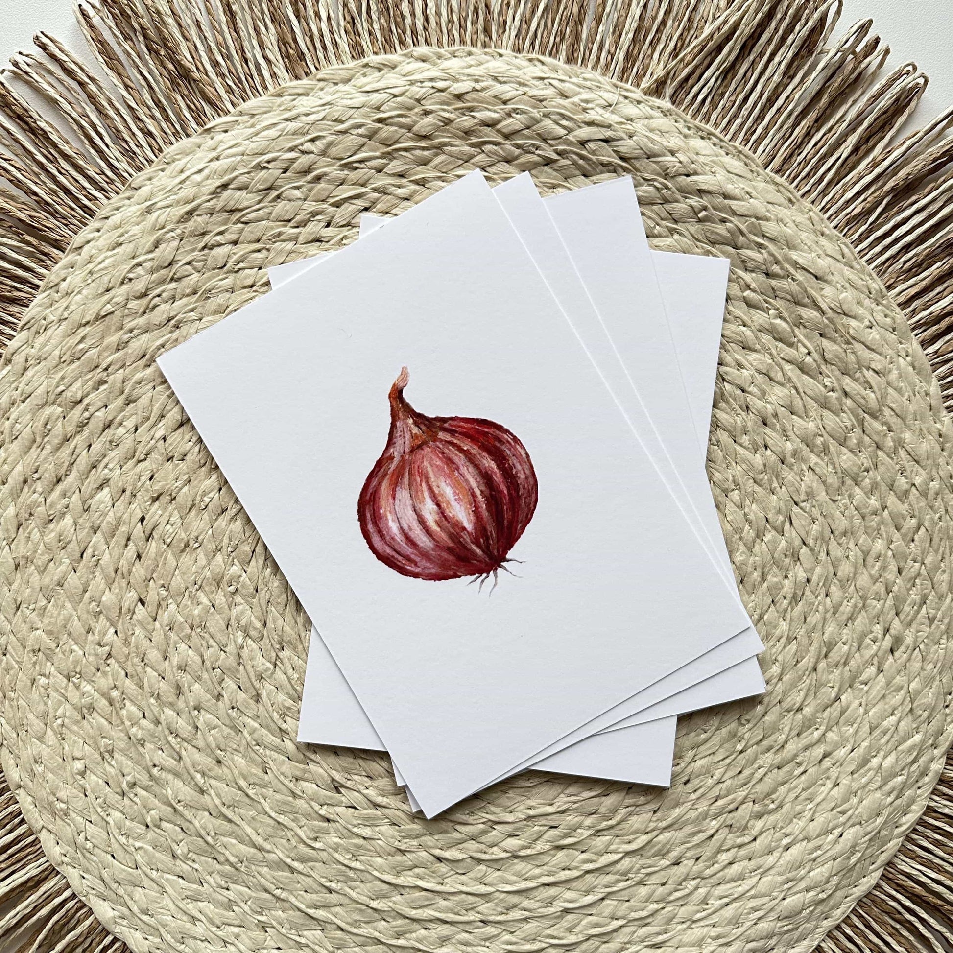 Set of greeting cards with a red onion illustration on a woven mat