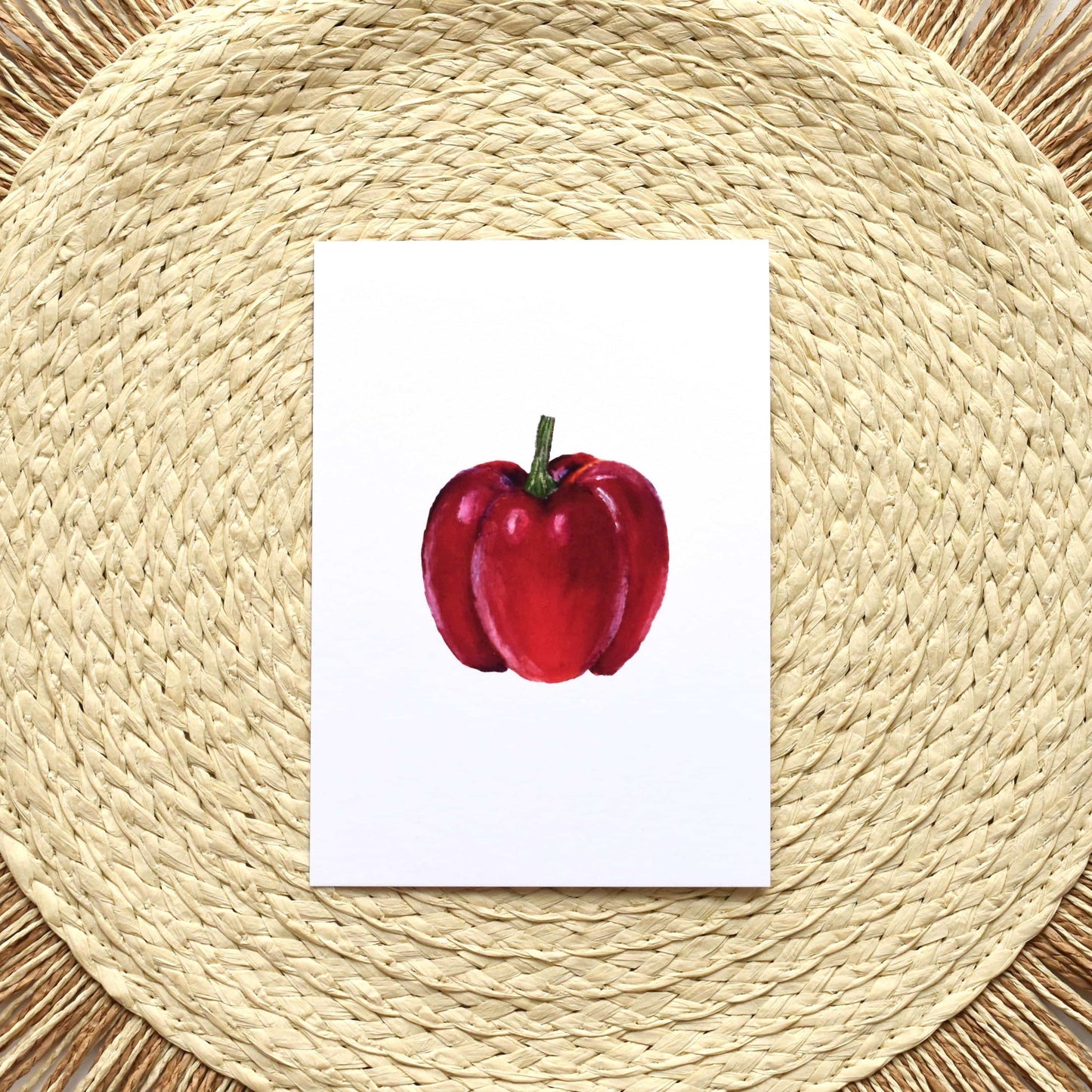 Red apple illustration on a white card placed on a woven placemat
