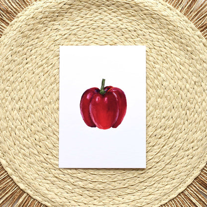 Red apple illustration on a white card placed on a woven placemat