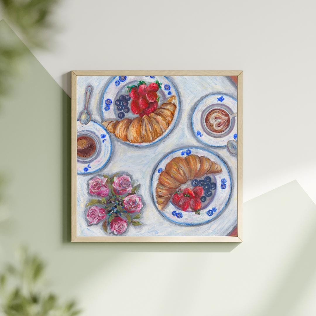 Flatlay of oil pastel breakfast digital artwork showing croissants, berries and blue dishes, printable kitchen art on soft green backdrop, HerPens
