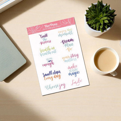 Handwritten flatlay of pastel quote sticker sheet with modern calligraphy on A6 paper soft aesthetic journaling stickers herpens