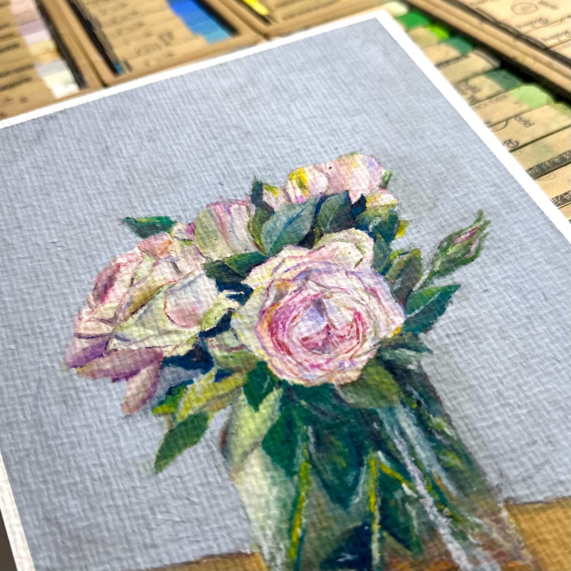 Close-up of pink roses oil pastel artwork showing expressive strokes and paper texture on fine art print, HerPens
