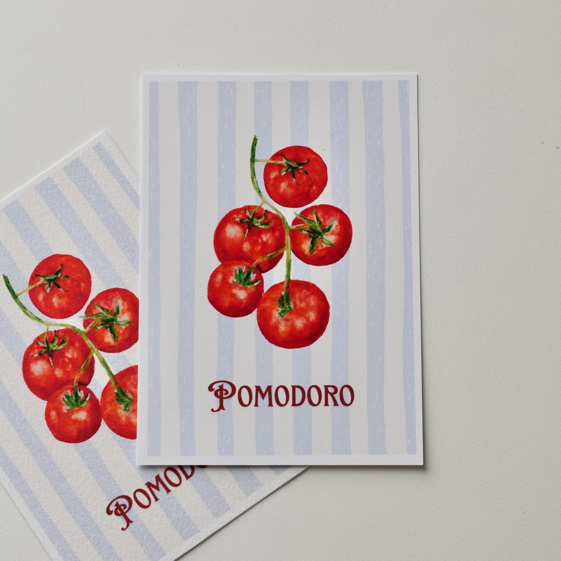 “Pomodoro” A6 postcard — ripe red tomatoes on blue stripes, printed on smooth matte paper, original oil pastel artwork by HerPens.