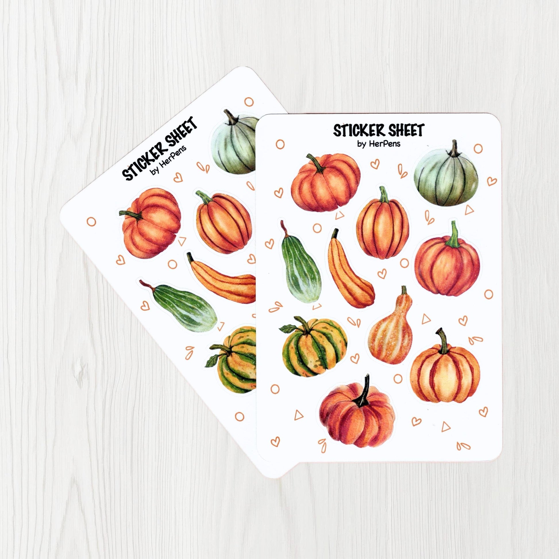 Handwritten close up of watercolor pumpkin stickers with rich autumn colors on matte sticker paper herpens
