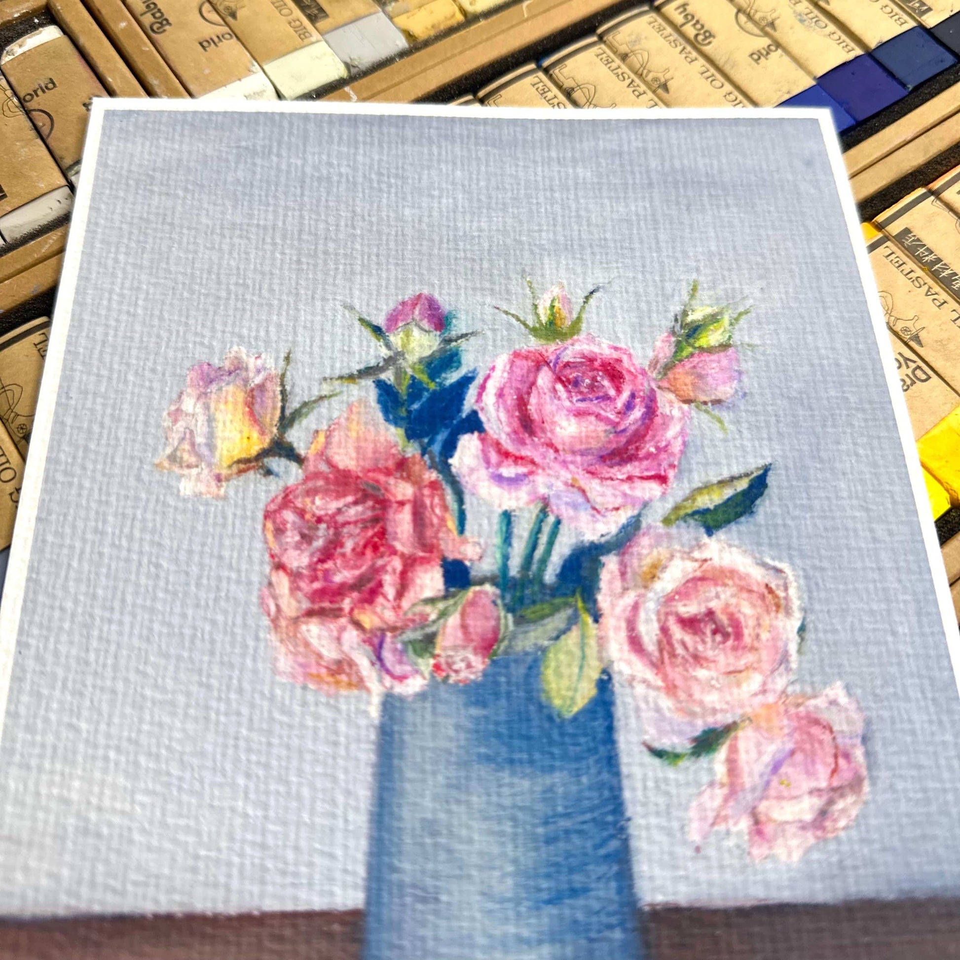Close-up of oil pastel pink roses showing expressive strokes and paper texture on 310 gsm textured fine art print, HerPens