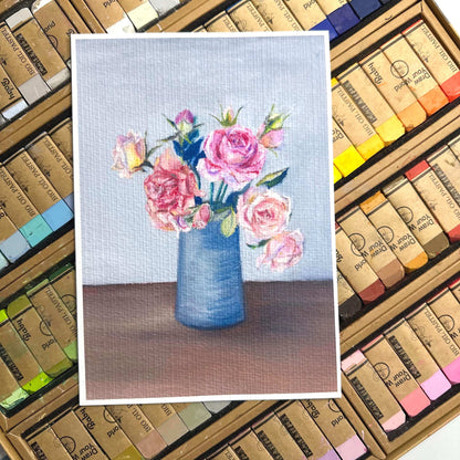 Oil pastel rose vase art print flatlay on pastel stick background, pink roses in blue vase printed on textured fine art paper, HerPens