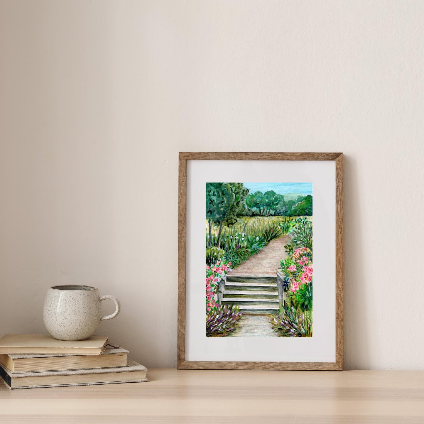 Summer Park digital print styled on a beige wall with books and ceramic mug, soft watercolor crayon garden illustration, HerPens
