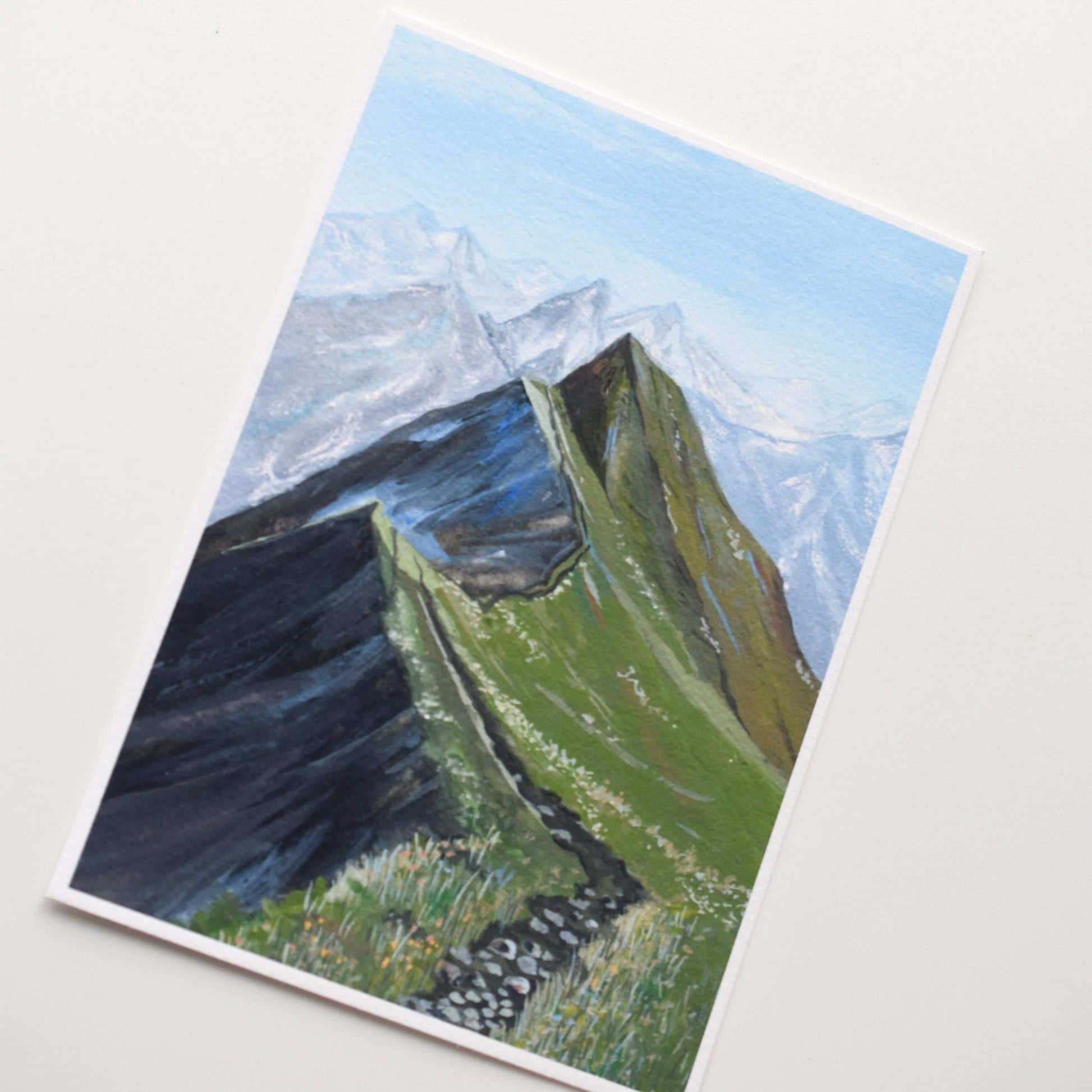 Painting of a mountain landscape with green slopes and snow-capped peaks on a white background