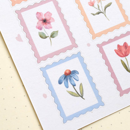 Detail of watercolor flower stamp stickers with visible cut lines on matte sticker sheet herpens
