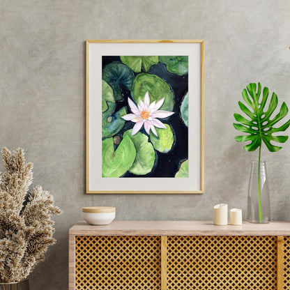 Framed Water Lily gouache digital artwork displayed above a wooden console with plant decor, soft garden-inspired floral illustration, HerPens