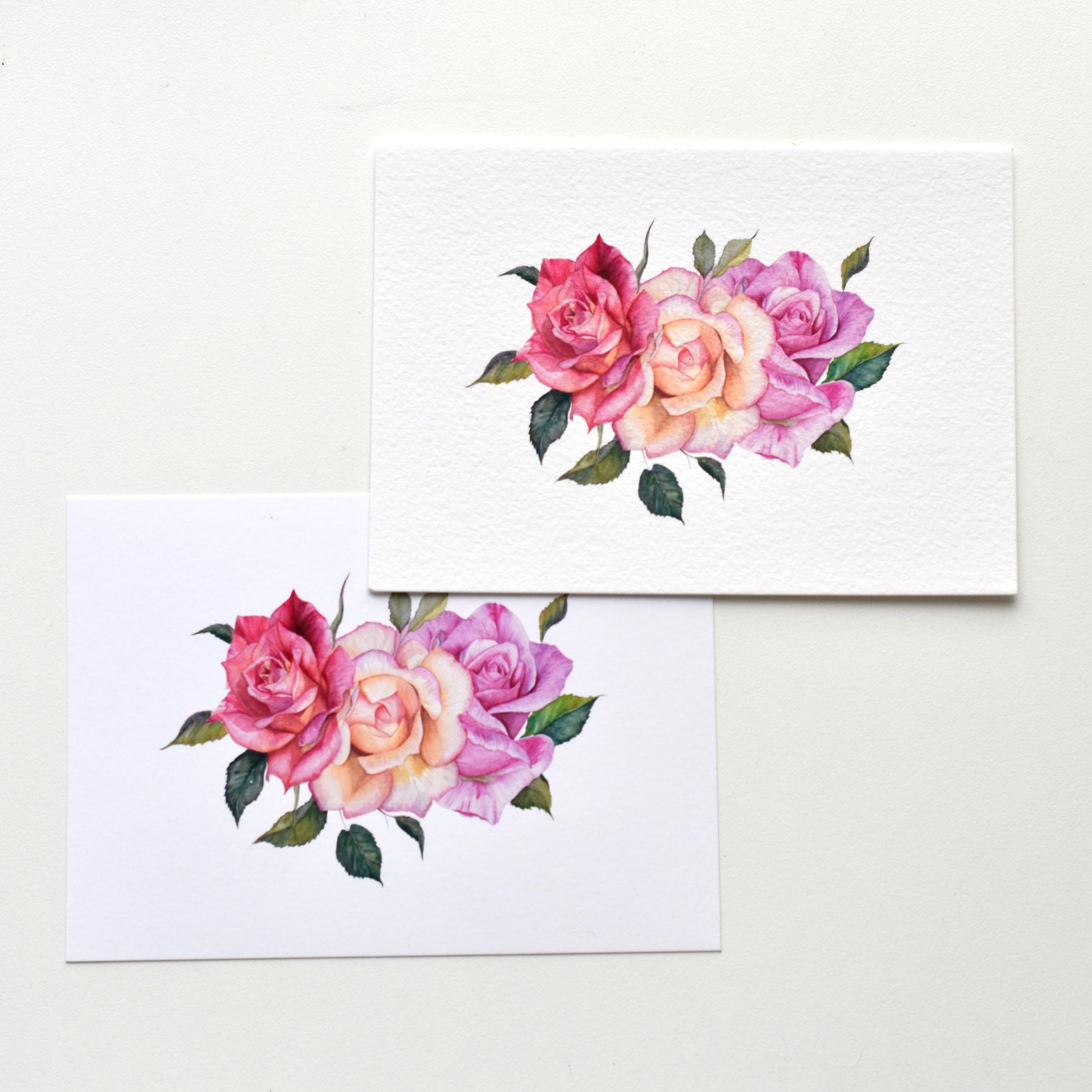 A6 watercolor roses postcards shown side by side on matte and textured paper, comparing print surfaces and floral details, HerPens