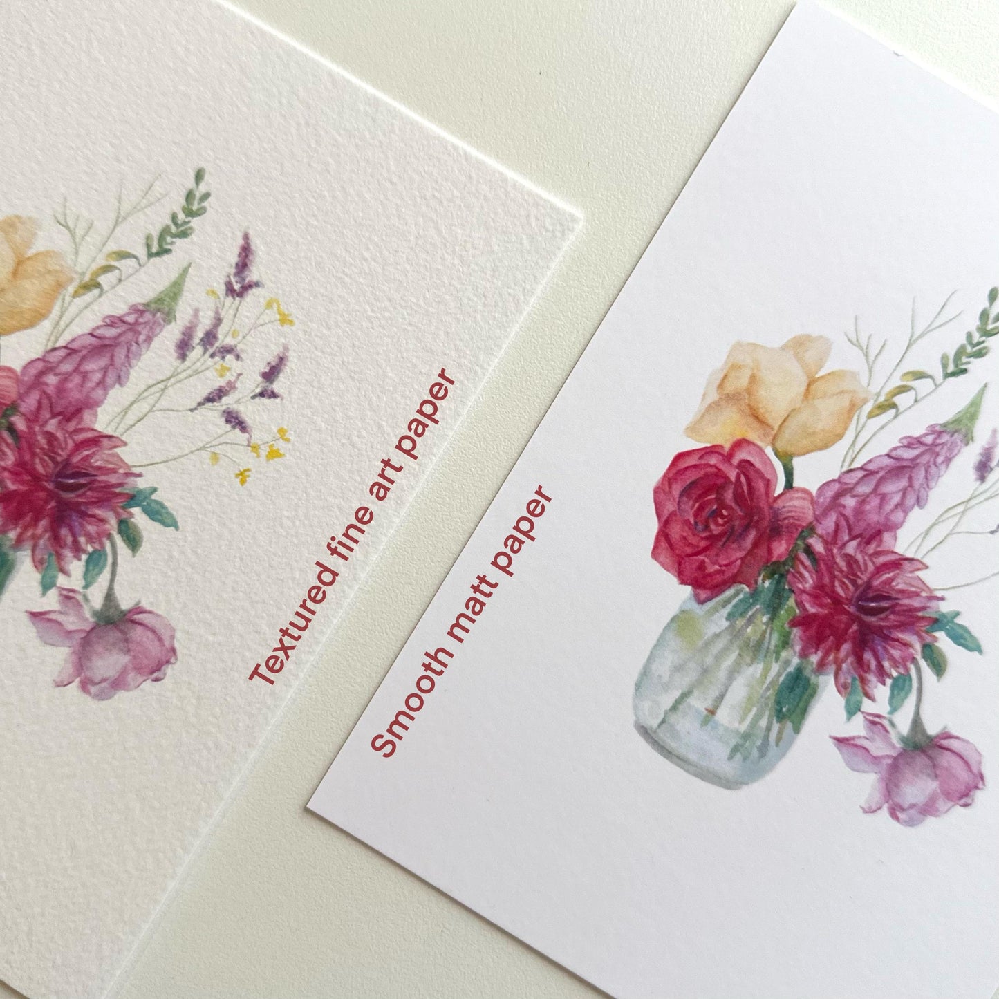 Side-by-side comparison of “Watercolour Flowers Vase” postcards labeled Smooth Matte and Textured Fine Art paper — showing finish and texture difference by HerPens.