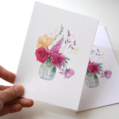 Hand holding the “Watercolour Magnolia” A6 art postcard printed on textured fine art 310 gsm paper — showing painterly surface and soft floral details by HerPens.